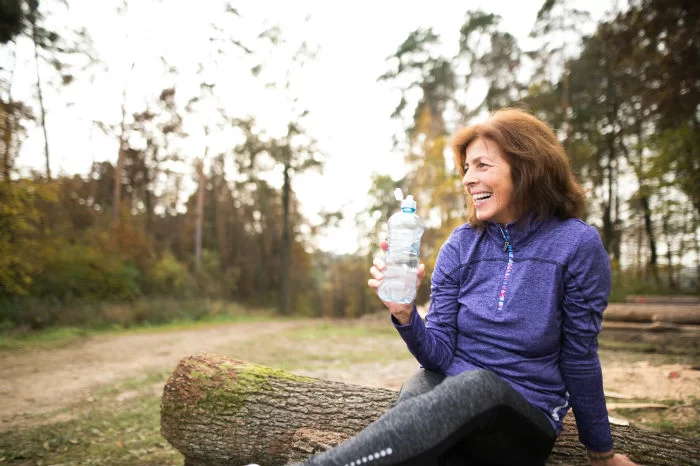A mature woman stops for a rest during a run
