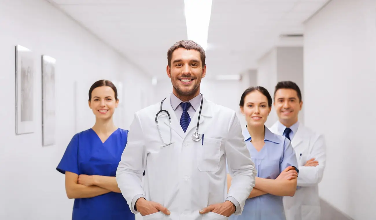 A confident and smiling team of medical professionals, including doctors and nurses, representing a leading stem cell therapy clinic in Newport News, VA.