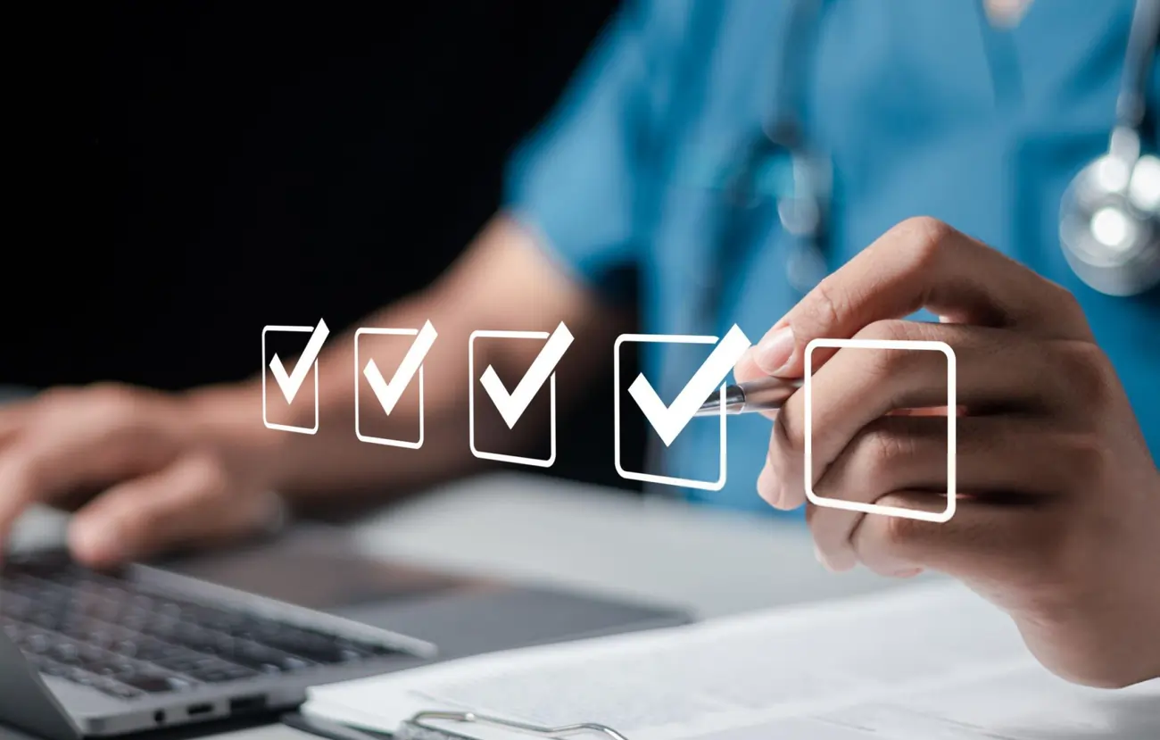 Doctor or medical professional completing a health checklist on a digital screen.