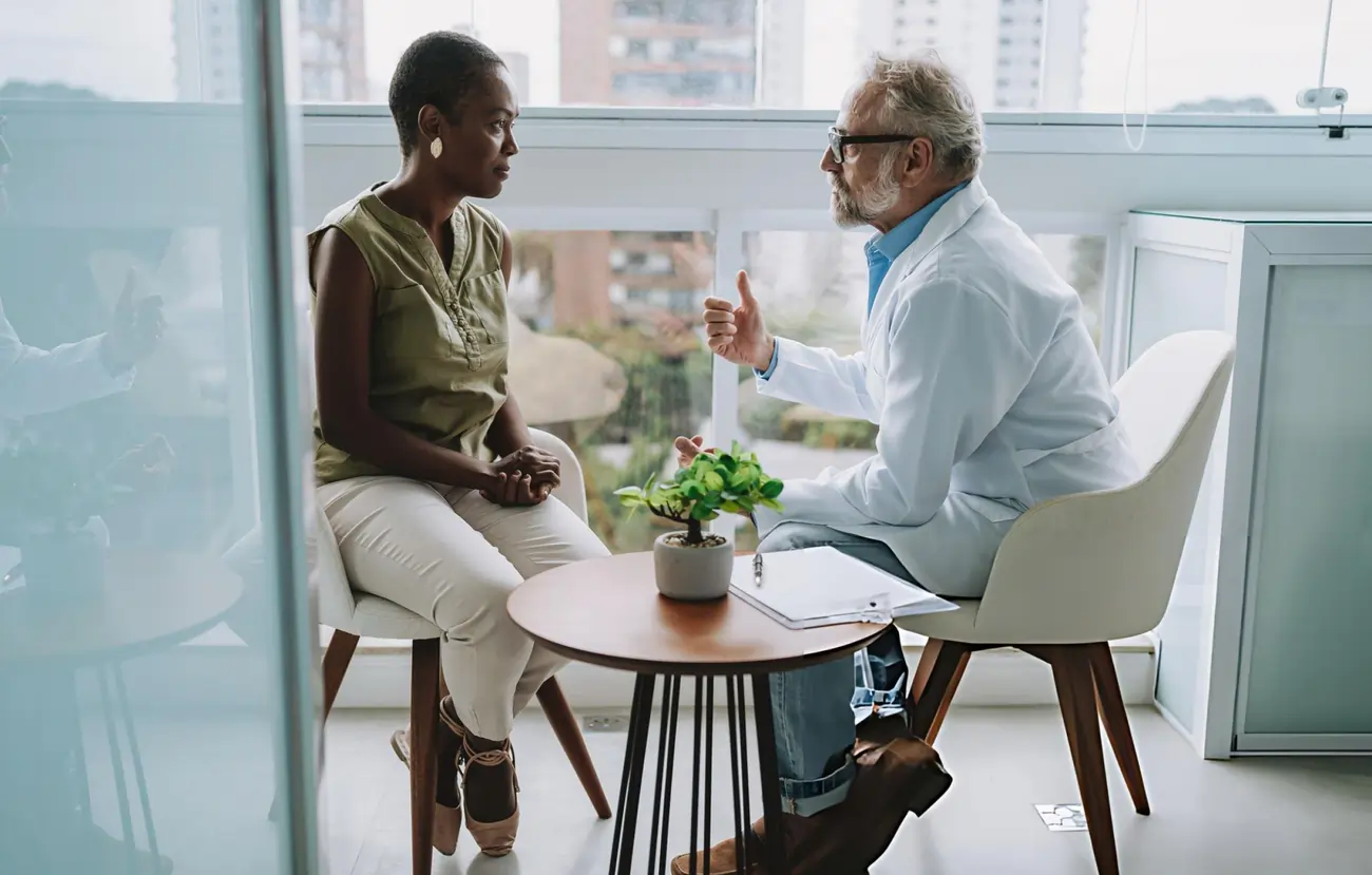 Doctor talking to a patient during a consultation in a clinic.