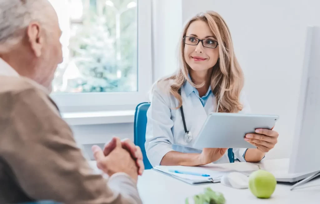 A professional medical consultation between a doctor and a patient discussing regenerative stem cell therapy options and personalized treatment plans