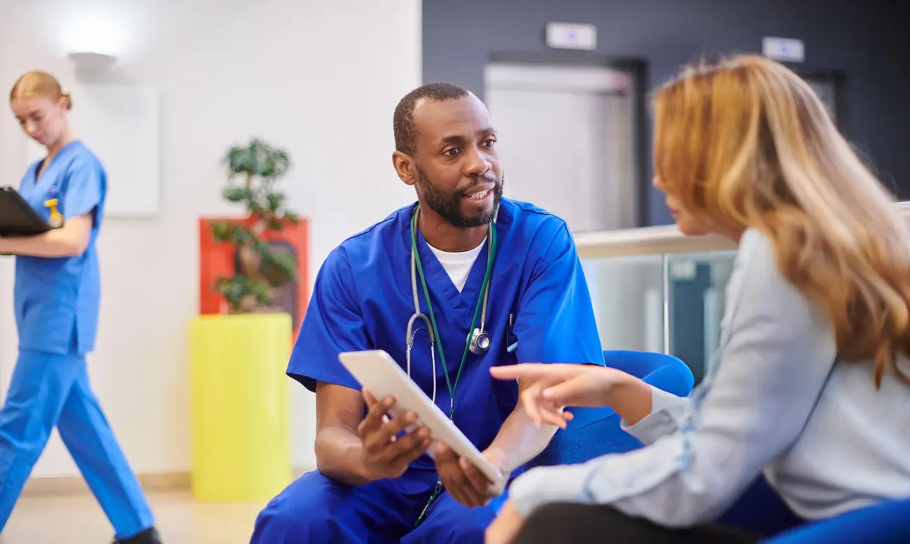 Doctor discussing treatment options with a patient in a medical clinic.
