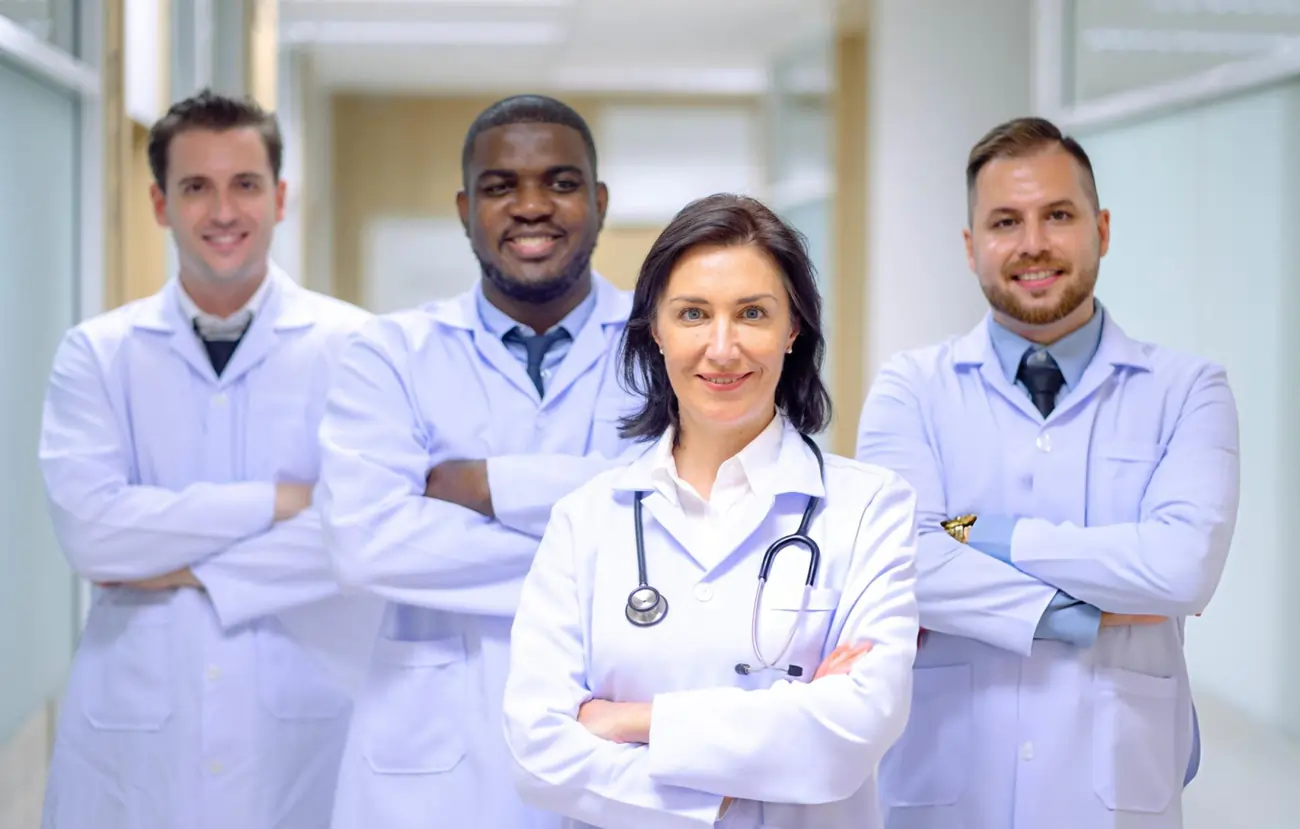 Diverse team of professional doctors wearing white coats.