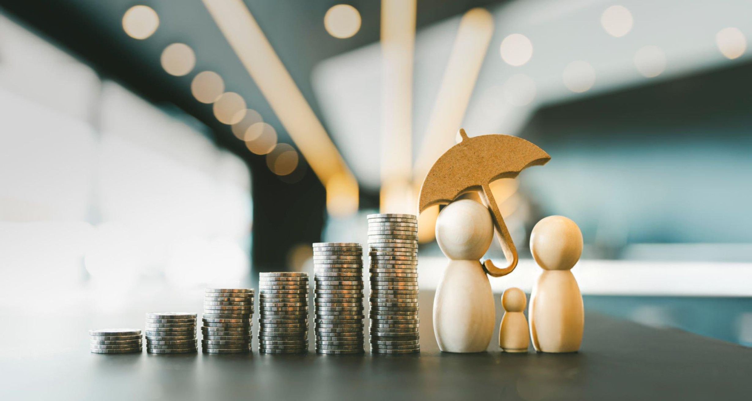 Stacked coins and umbrella-covered figures—symbolizing secure, flexible insurance and payment options for stem cell therapy in Norfolk