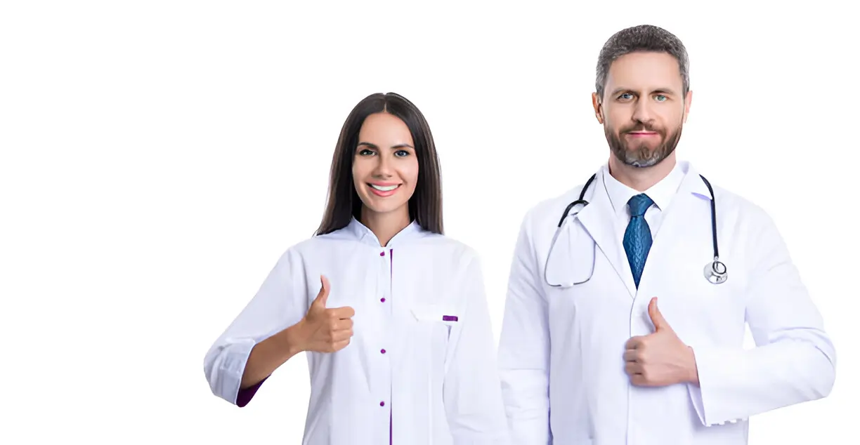 Two smiling doctors, a man and a woman, giving thumbs-up for quality care.