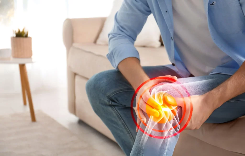 Person holding painful knee with digital overlay, representing evaluation of stem cell therapy benefits and drawbacks for knee conditions