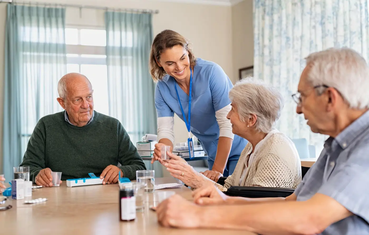 Nurse assisting seniors with medication management in a residential assisted living facility.