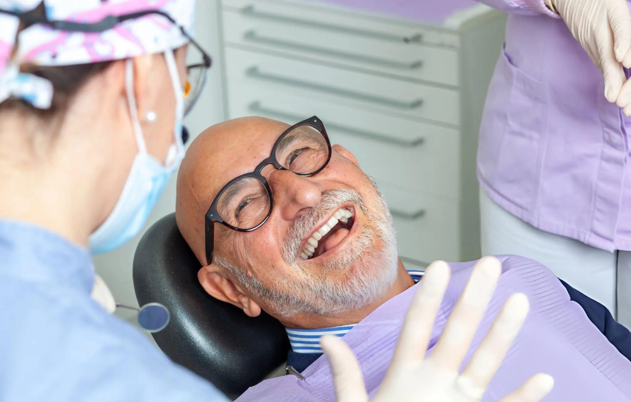 Smiling elderly patient in dental chair—symbolizing trusted, patient-centered regenerative care from R3 Stem Cell
