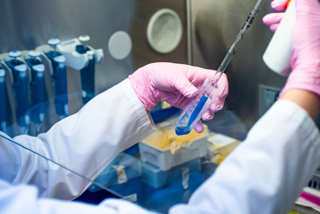 Laboratory technician handling mesenchymal stem cell sample used in regenerative medicine from umbilical cord tissue and bone marrow