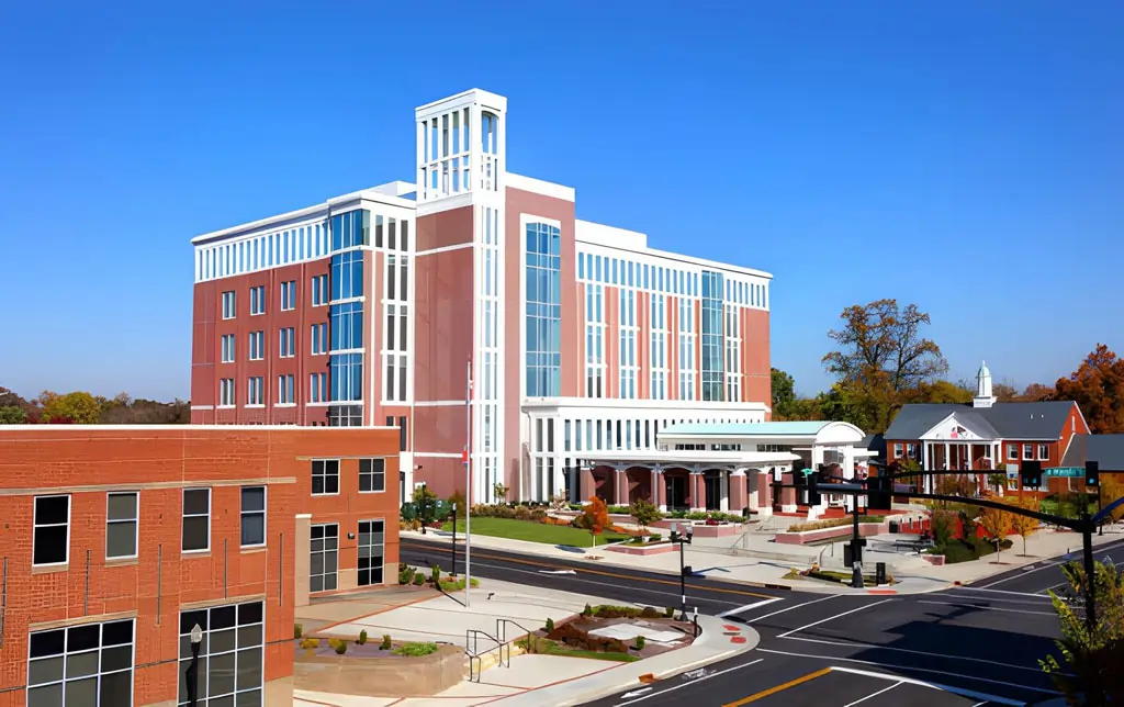 A bright daytime street view of a modern multi-story building in Murfreesboro, Tennessee, representing the local healthcare resources available for MTSU athletes and active residents seeking regenerative therapy.