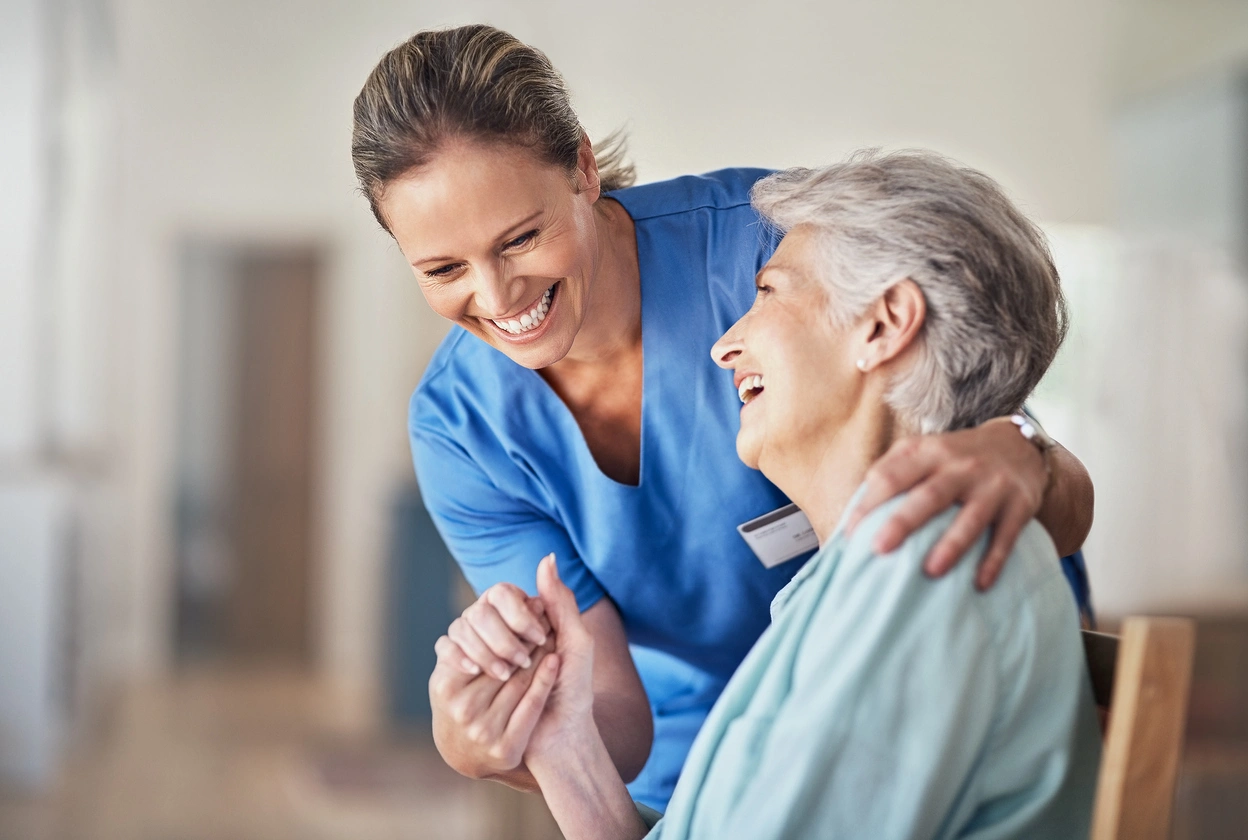 Healthcare professional supporting and comforting elderly patient during regenerative therapy consultation