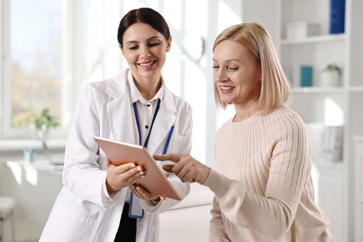 Doctor discussing treatment and financing options with a patient in a professional medical office, highlighting free consultation.