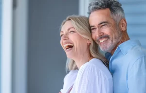 Happy middle-aged couple smiling and laughing together outdoors in natural light