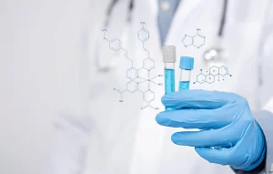 A medical professional in a white lab coat and blue sterile gloves holding two laboratory test tubes filled with blue fluid, overlayed with digital chemical structure diagrams.