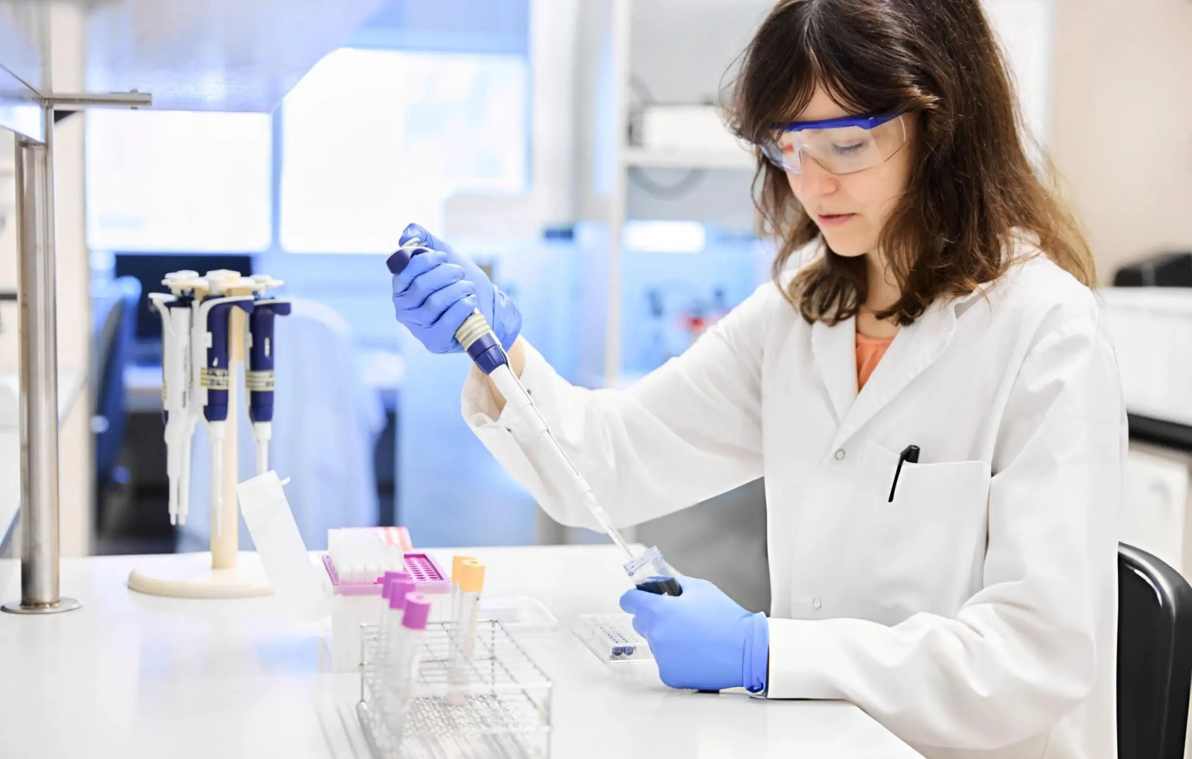 Scientist pipetting exosome samples in a regenerative medicine laboratory