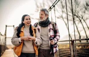 Happy active mature couple walking outdoors after stem cell therapy
