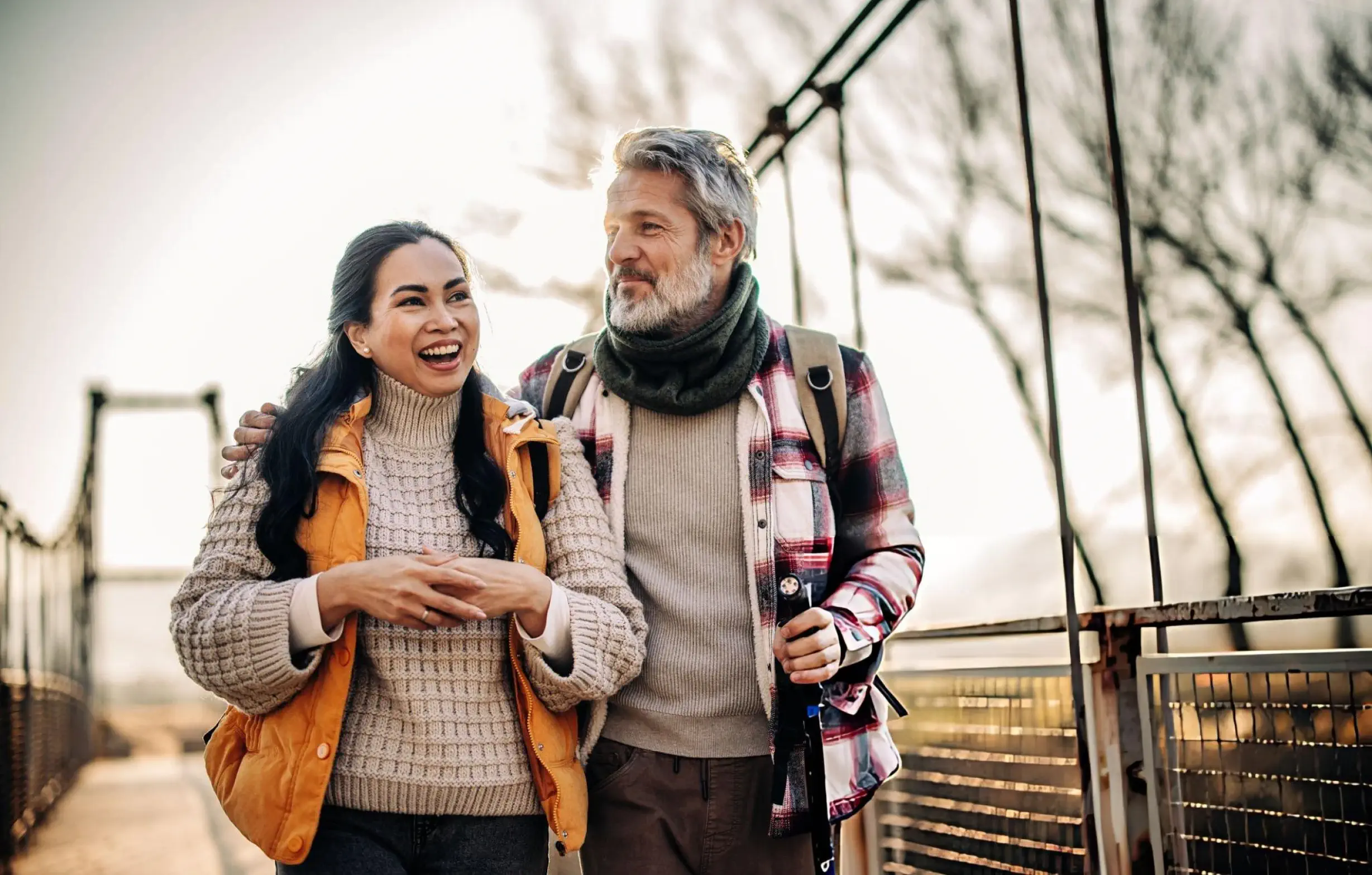 Happy active mature couple walking outdoors after stem cell therapy
