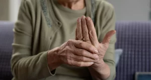Senior patient experiencing hand tremors from Parkinson's disease.