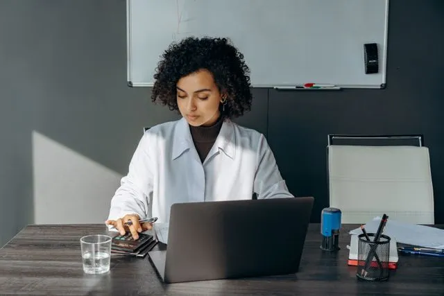Clinician calculating stem cell treatment costs to explain pricing transparency to patients