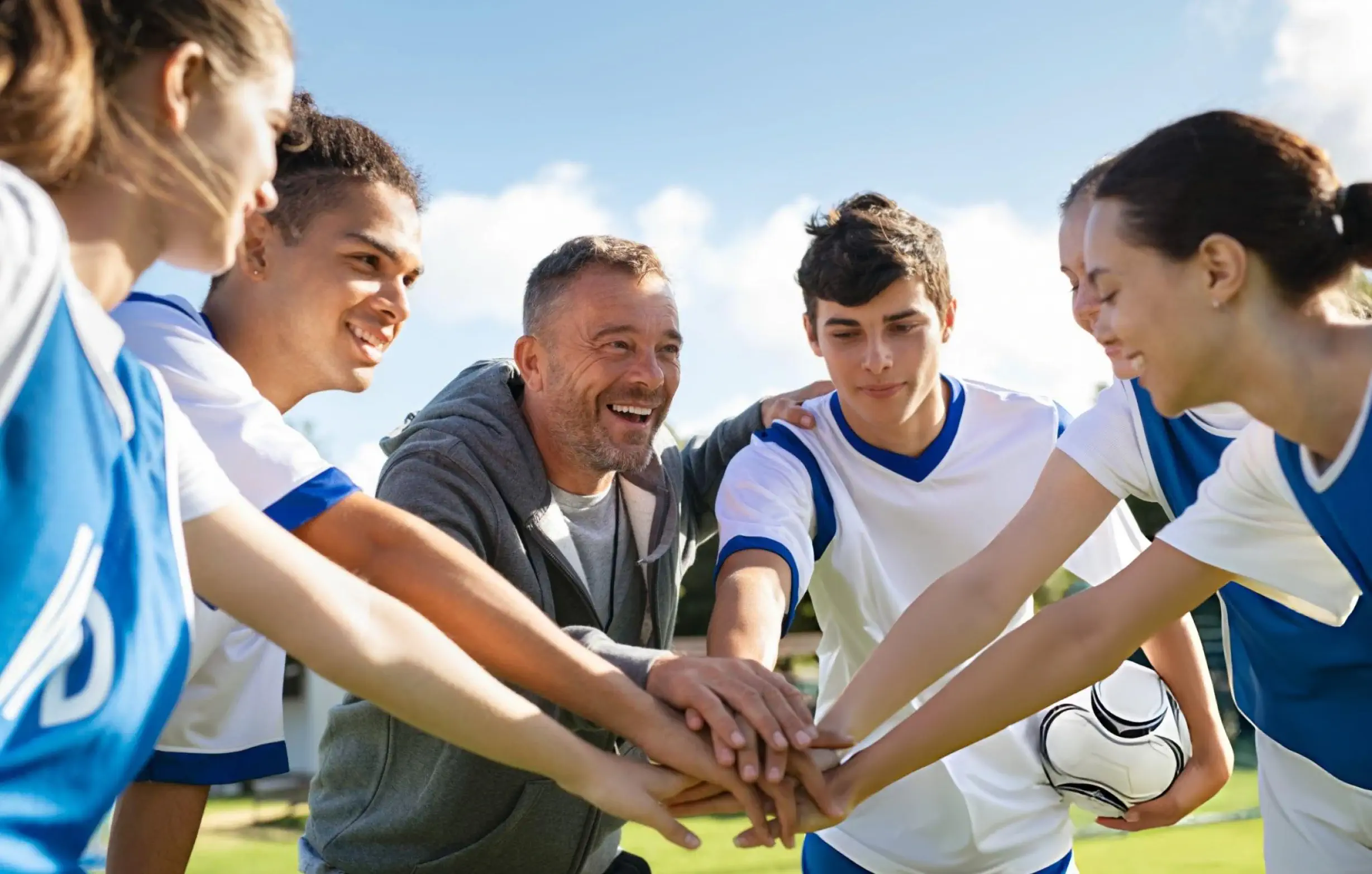 Athletes joining hands after non-surgical joint pain relief
