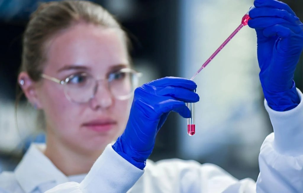 Lab researcher preparing stem cell therapy samples in test-tube