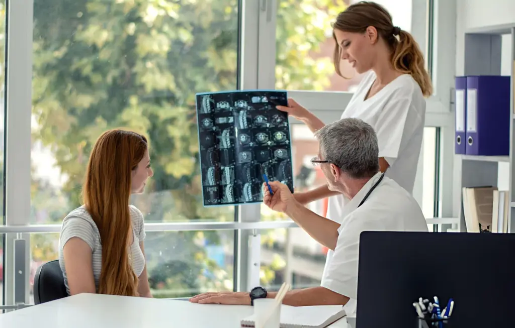 Medical team examining spine scans during stem cell consultation